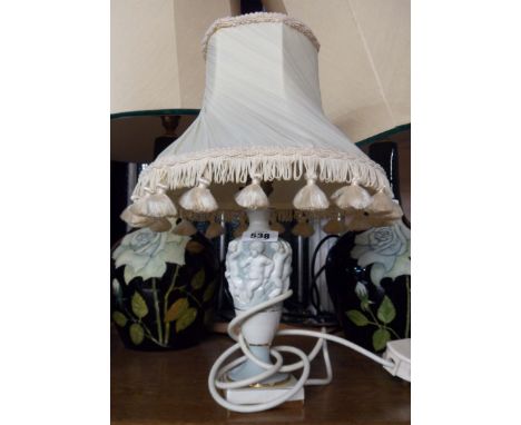 A vintage Italian pottery lamp decorated with a frieze of cavorting putti