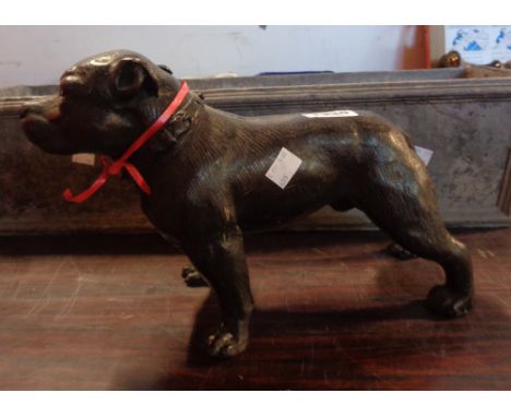 A cast brass model of a Staffordshire bull terrier with bronzed finish