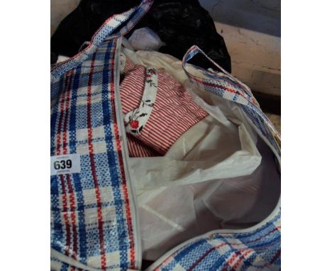 Two bags containing a quantity of textiles including duvet cover, cushion covers, etc.