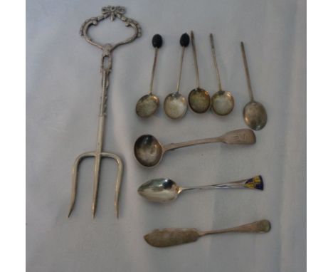 A silver muffin fork with ornate bow pattern handle - marks worn - sold with five damaged silver coffee bean spoons, two othe