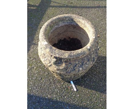 A Cotswold stone concrete garden planter of urn form with stylised chain link decoration