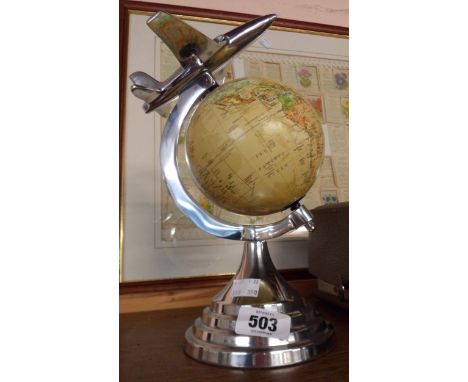 A reproduction Art Deco style globe of the world with aeroplane to top