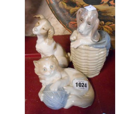 A Lladro figurine of a dog in a basket - sold with two further Nao figurines of a dog and a cat