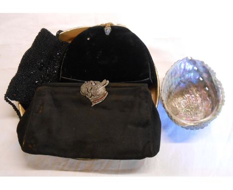 An Art Deco period black evening bag with plated metal and marcasite clasp in the form of a bulldog's head - sold with a bead