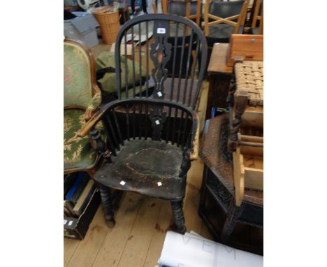 An antique painted wood Windsor style stick back elbow chair with pierced splat and solid moulded seat, set on ring turned su