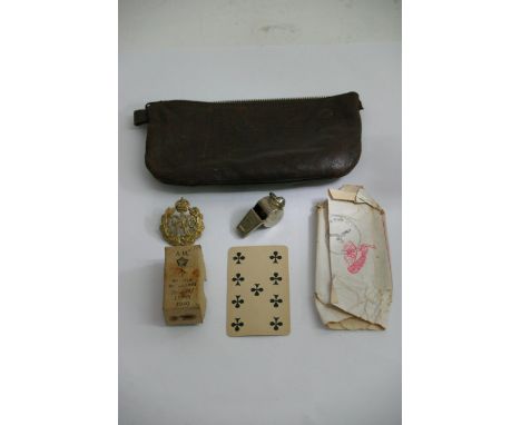 A RAF interest 'Goldfish Club' cap badge ( for being rescued at sea), plus a wrapper  containing a playing card stamped ' Sta