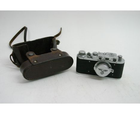 A Russian copy of a German 1936 Leica Olympiada camera, Eagle logo to lens cap, leather case embossed 'Made in USSR'