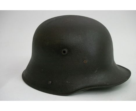 A German WWII Stalhelm Mig original tin helmet, with loss of paint but with nice patina and lining