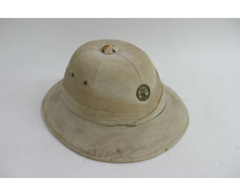 A Pith helmet fitted with a sand cast Long Range Desert group capbadge, worn sold a/f