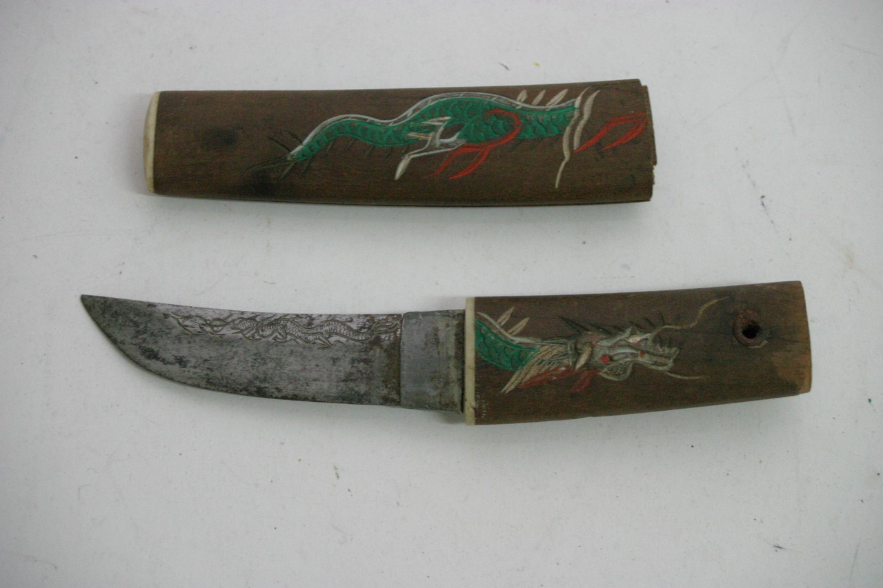 A 1940's Japanese knife with carved wooden handle and sheath depicting