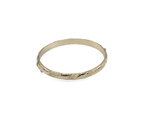 A 14ct gold tested bangle decorated with diamond style decoration weight 14.5 grams.