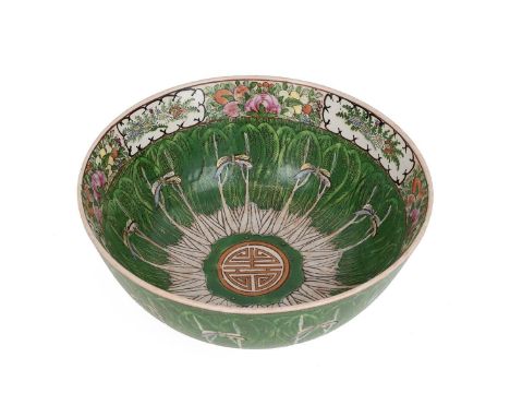 A Late Qing dynasty Famille Verte bow. The outside decorated in green enamel having floral details to the rim with butterflie