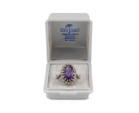 18ct white gold amethyst cluster ring hallmarked Sheffield/London 750, the central amethyst approx 1.7cm mounted in a claw se