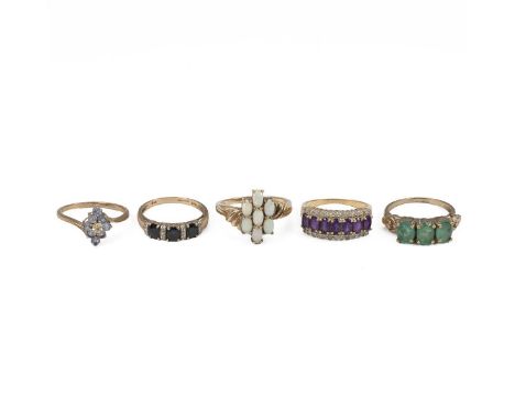 Four 9ct gold gem set rings, 11.6 grams, along with a gem set yellow metal ring, unmarked, 3.4 grams.