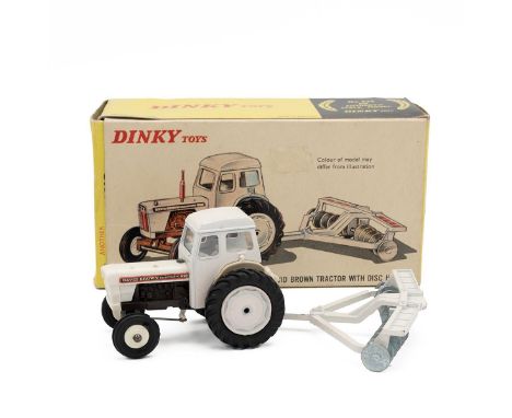 Boxed Dinky Toys David Brown tractor with Disc Harrow, No.325, in white.