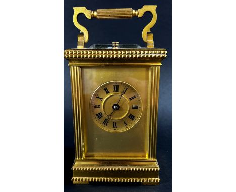 A 19th century brass French carriage clock, the case with reeded and decorative borders, with eight day striking movement and