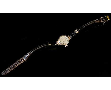 Rotary: A ladies 9ct yellow gold cased wristwatch, 15mm case, with textured lugs, leather strap. 