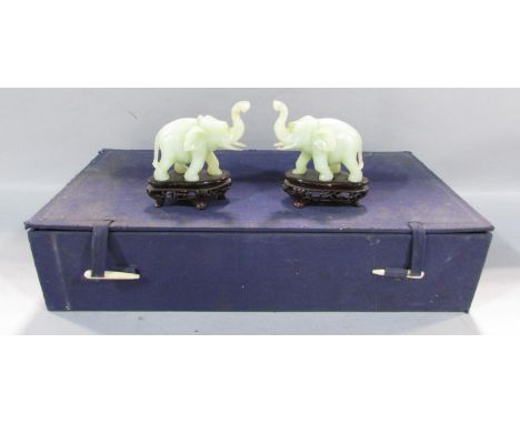 A pair of Chinese carved hard stone / bowenite jade elephants, one with restored break to trunk in silk box with stands 