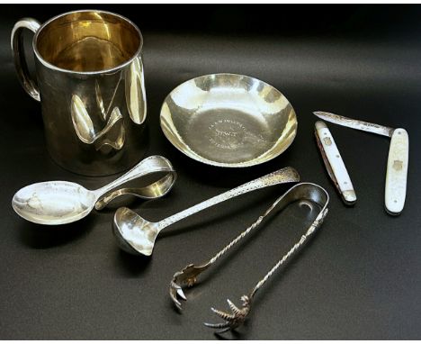 A mixed collection of silver items to include  pen tray, christening mug, a centenary dish, a sauce ladle, sugar tongs, two m