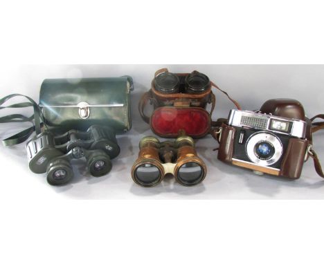 A Voigtlander vintage camera, a pair of military binoculars, a pair of green rubberised water resistant binoculars and a pair