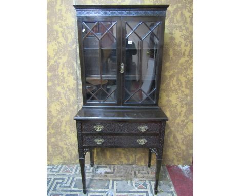 An Edwardian Chippendale revival side cabinet, the lower section with two long frieze drawers with blind fret detail raised o