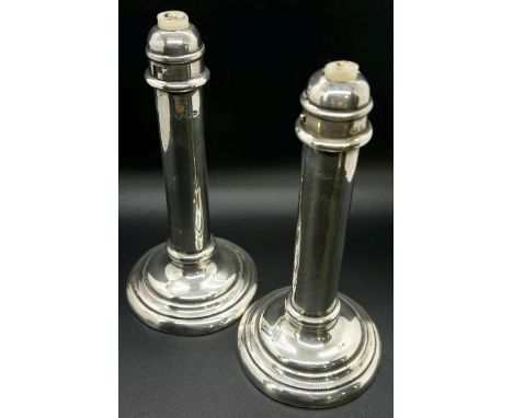 A pair of students silver sprung candlesticks, Birmingham 1903, makers mark rubbed, together with a pair of hexagonal based a
