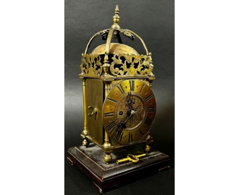 A small 19th century lantern clock of usual form with single train fusee movement, set on a square cut timber bracket, 23cm h