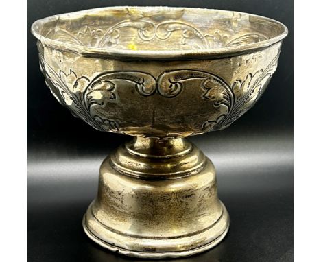 A late Victorian silver sugar bowl decorated with a rural milking scene, raised on three lion mask paw feet, 13cm diameter, C