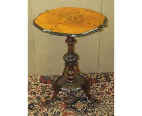 A 19th century walnut inlaid lamp table on turned pillar and flamboyant carved base, 50cm wide 