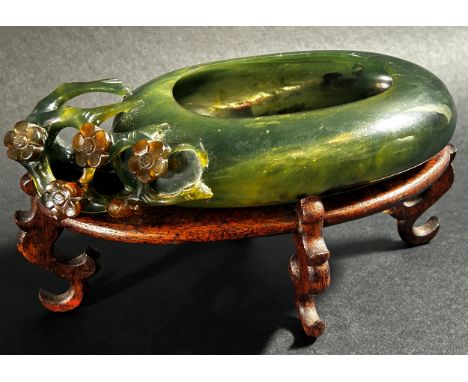 A Chinese translucent spinach green bowenite jade brush washer, of peddle form carved with flowering prunus blossoms, 17 x 9c