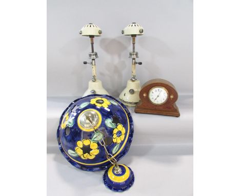 A pair of Bialaddin pressure table lamps Model T.10, an Edwardian mahogany mantel clock inlaid with mother-of-pearl and a gla