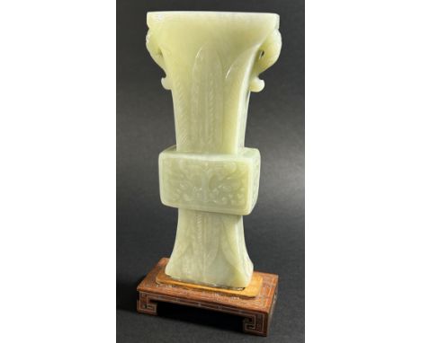 A Chinese archaistic style carved pale mutton fat jade / hardstone vase, of tapering flared form, carved throughout in shallo