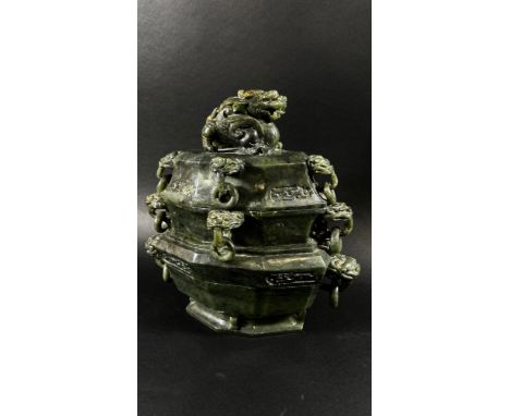 A large archaistic style Chinese spinach green bowenite jade lidded censor, with ringed temple lion mask mounts, the cover su