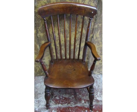 A 19th century Windsor stick back armchair with elm seat and beechwood supports, 