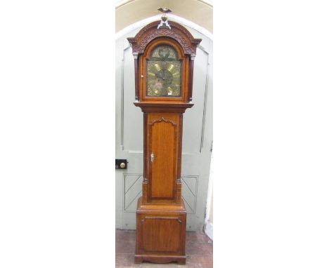 A Georgian oak longcase clock, the trunk crossbanded in walnut and with reeded column supports, the hood with arched outline,