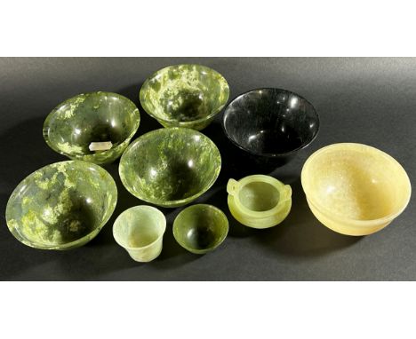 A collection of Chinese bowenite jade / hardstone bowls pf varying size / form to include a matched set of four (5cm high, 10