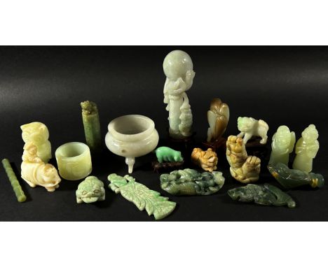 An interesting collection of Chinese carved jade, bowenite jade and hard stone objects to include a pale celadon archer’s rin