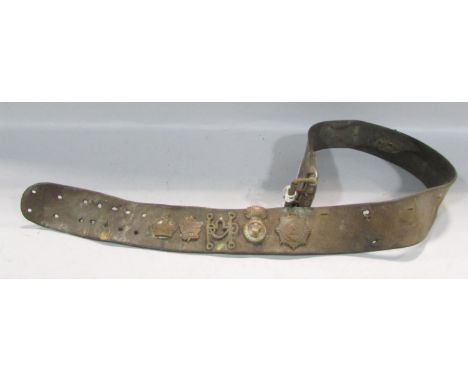 A leather belt with military badges, including an Australian Commonwealth Military Forces, Royal Welsh Fusiliers, British Sad
