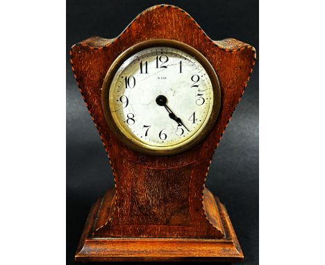 An Edwardian mahogany mantle clock with shaped outline, chequered string borders and eight day timepiece 
