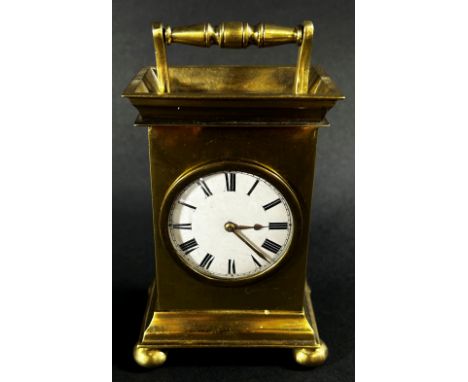 A small 19th century brass mantle clock, the circular enamel dial with a small fusee movement and decorative back cock, numbe