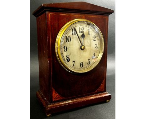 An inlaid mahogany Edwardian mantle clock, with silvered dial, pendulum 