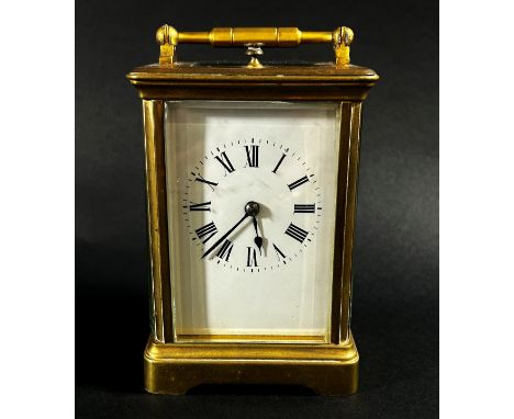 A brass carriage clock with eight day striking movement with repeat, currently running 