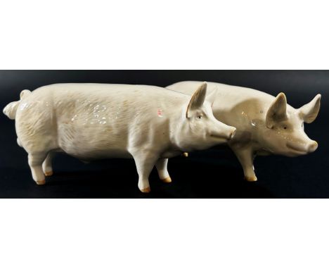 A collection of Beswick porcelain animals to include two pigs, a ewe and three lambs 