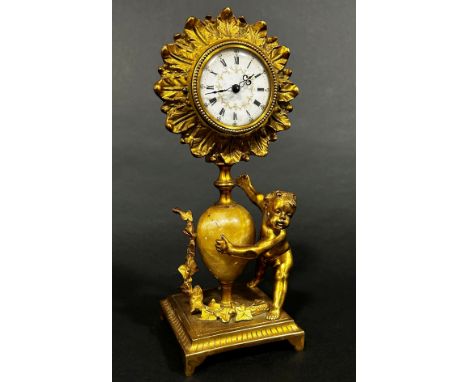 19th century gilt mantle clock the painted dial within a flower head border, surmounted on an onyx shaped stem, 22cm high