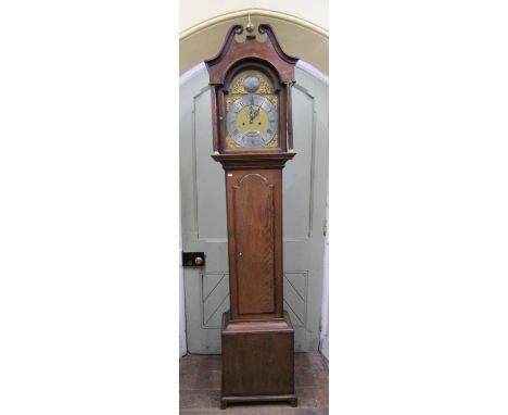 A 19th century oak longcase clock the hood with swan neck pediment enclosing a broken arch brass dial and eight day striking 