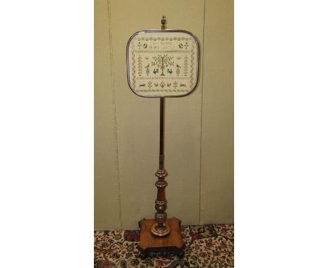 A late Georgian mahogany pole screen on turned column and platform base with tapestry panel, 