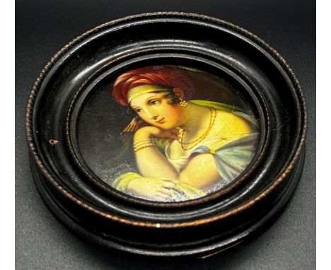 A 19th century continental painted and lacquered papier-mâché patch box cover, decorated with a portrait of a maiden 