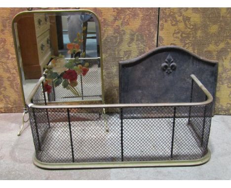 A small simple cast iron fire back of arched form with fleur-de-lys detail, 42 cm high x 57 cm wide, together with a  brass f