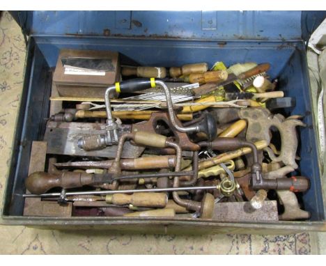 A steel trunk containing a good miscellaneous selection of hand tools, braces, bits, handsaws, chisels, screwdriver, etc 