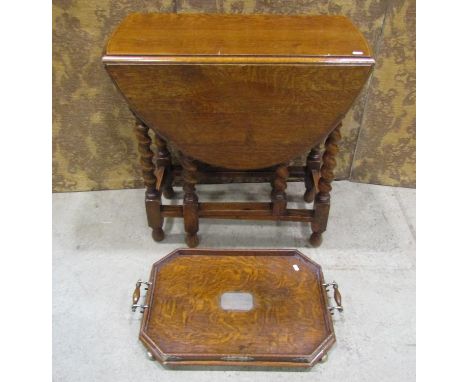 An Edwardian oak tea tray, with silver plated mounts and central engraved plaque, together with a 1920s oak gateleg occasiona